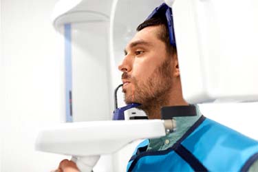 Man using 3D cone beam scanner for dental implants in Schenectady