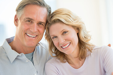 Older smiling couple with healthy teeth and gums