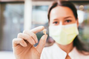 Dental team member holding extracted tooth