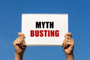 Hands holding “myth busting” sign