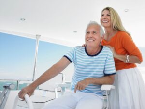 Smiling older couple on a boat during summer